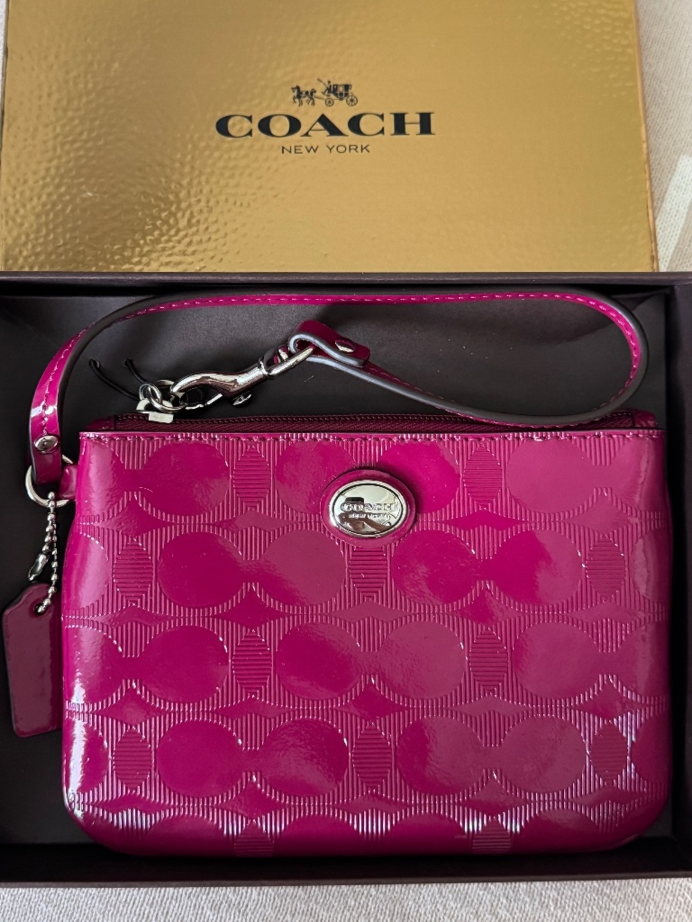 Coach F52282 cranberry embossed C patent wristlet NWT
